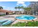 Community swimming pool area with lounge chairs on brick patio at 1170 Calle Del Rey # D, Casselberry, FL 32707