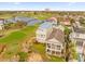 Aerial view capturing the home's proximity to a serene lake and the expansive golf course at 1432 Titian Ct, Reunion, FL 34747