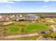 Beautiful home set against the backdrop of a scenic golf course and lush greenery, seen from above at 1432 Titian Ct, Reunion, FL 34747