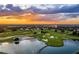 Aerial image shows community on a golf course at sunset, offering stunning views and serene atmosphere at 1432 Titian Ct, Reunion, FL 34747