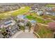 Aerial view of stunning property showcasing the pool, manicured landscaping, and golf course community at 1432 Titian Ct, Reunion, FL 34747