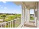 Enjoy golf course views from this relaxing balcony, framed by elegant white columns and railings at 1432 Titian Ct, Reunion, FL 34747