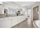 Bathroom with double vanity, soaking tub, and tiled floor at 1432 Titian Ct, Reunion, FL 34747