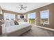 Primary bedroom with carpet, a ceiling fan, exterior doors and a view of the neighborhood at 1432 Titian Ct, Reunion, FL 34747