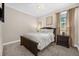 Comfortable bedroom with a ceiling fan, large bed, and ample natural light from the window at 1432 Titian Ct, Reunion, FL 34747