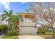 Charming two-story home featuring a spacious garage, brick driveway, and a welcoming American flag at 1432 Titian Ct, Reunion, FL 34747