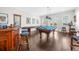 Bright game room includes a wet bar, shuffleboard, pool table, and lots of light from the windows at 1432 Titian Ct, Reunion, FL 34747