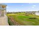 Panoramic view of the meticulously maintained golf course and lush landscaping from the balcony at 1432 Titian Ct, Reunion, FL 34747