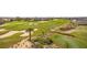 Expansive aerial view of the meticulously maintained golf course and vibrant landscaping of this golf course community at 1432 Titian Ct, Reunion, FL 34747