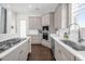 Bright kitchen features stainless steel appliances, a gas range, quartz countertops and dark wood floors at 1432 Titian Ct, Reunion, FL 34747