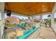 Outdoor seating area with a fire pit and full kitchen with bar at 1432 Titian Ct, Reunion, FL 34747
