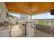 Outdoor kitchen with granite counters, overlooking the neighborhood and golf course at 1432 Titian Ct, Reunion, FL 34747