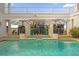 Relaxing pool and spa with detailed tile work, surrounded by lush greenery and elegant umbrellas for shade at 1432 Titian Ct, Reunion, FL 34747