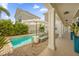 Private pool and spa area with brick pavers, lush tropical landscaping, and covered seating for outdoor enjoyment at 1432 Titian Ct, Reunion, FL 34747