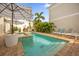 Private pool and spa with elegant poolside lounging and tropical landscaping for a serene outdoor experience at 1432 Titian Ct, Reunion, FL 34747