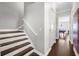 Staircase leading to an upstairs game room featuring hardwood floors and white trim at 1432 Titian Ct, Reunion, FL 34747