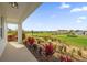 Relaxing view of the golf course from the covered patio with vibrant flora and manicured landscape at 1432 Titian Ct, Reunion, FL 34747