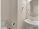 Powder room with pedestal sink, round mirror, and white walls at 15489 Honeybell Dr, Winter Garden, FL 34787