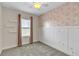 Bright bedroom with large window, pink accent wall, shelving, and plush carpeting at 15489 Honeybell Dr, Winter Garden, FL 34787