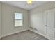 Simple bedroom with a ceiling fan and carpeted floors, decorated with floral decals at 15489 Honeybell Dr, Winter Garden, FL 34787