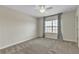 Neutral bedroom with plush carpet, ceiling fan, and a window with blinds and grey curtains at 15489 Honeybell Dr, Winter Garden, FL 34787