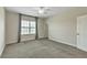 Large bedroom with plush carpeting, large window, and neutral walls at 15489 Honeybell Dr, Winter Garden, FL 34787