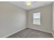 Simple bedroom with a ceiling fan and carpeted floors, decorated with floral decals at 15489 Honeybell Dr, Winter Garden, FL 34787