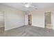 Spacious bedroom with carpet flooring, ceiling fan, and ensuite bathroom access at 15489 Honeybell Dr, Winter Garden, FL 34787