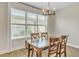 Bright dining room with a chandelier and large window at 15489 Honeybell Dr, Winter Garden, FL 34787