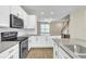 Modern kitchen featuring white cabinets, granite countertops, and stainless steel appliances at 15489 Honeybell Dr, Winter Garden, FL 34787