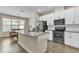 Modern kitchen with granite countertops, stainless steel appliances, and white cabinetry at 15489 Honeybell Dr, Winter Garden, FL 34787