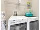Laundry room with washer, dryer, and storage shelf at 15489 Honeybell Dr, Winter Garden, FL 34787
