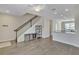 Open living space showcasing modern floors, recessed lighting, and convenient staircase access at 15489 Honeybell Dr, Winter Garden, FL 34787