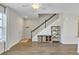 Inviting living room featuring sleek floors, a stylish staircase, and ample natural light at 15489 Honeybell Dr, Winter Garden, FL 34787