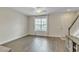 Bright living room with wood floors, large window, and staircase at 15489 Honeybell Dr, Winter Garden, FL 34787