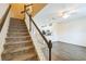 Staircase leading to an open floor plan with kitchen and living area at 15489 Honeybell Dr, Winter Garden, FL 34787