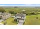 Aerial view of a two-story home with a large backyard and lush green grass, and a glimpse of the surrounding wetland at 16413 Bloom Ct, Groveland, FL 34736