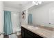 Well-lit bathroom features a spacious countertop, dark cabinetry, shower and tub combination, and modern fixtures at 16413 Bloom Ct, Groveland, FL 34736