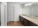 Bright bathroom features a large mirror, vanity with great counter space, and a shower with glass doors at 16413 Bloom Ct, Groveland, FL 34736