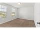 This bright bedroom features plush carpeting, and abundant natural light streaming through two windows creating a warm ambiance at 16413 Bloom Ct, Groveland, FL 34736