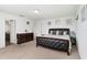 Spacious bedroom featuring a king-size bed, a dresser, and ample closet space with access to the bathroom at 16413 Bloom Ct, Groveland, FL 34736