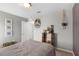 Neutral bedroom with gray walls, light carpet, and a display shelf creates a tranquil and inviting retreat at 16413 Bloom Ct, Groveland, FL 34736
