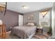 This bedroom is complete with a comfortable bed, a sunny window and stylish decor for a cozy retreat at 16413 Bloom Ct, Groveland, FL 34736
