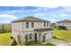 Exterior of a two-story home featuring manicured landscaping, an attached two-car garage and an adjacent green space at 16413 Bloom Ct, Groveland, FL 34736