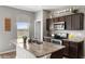 Well-lit kitchen featuring granite countertops, stainless steel appliances, and ample cabinet space at 16413 Bloom Ct, Groveland, FL 34736
