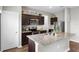 Updated kitchen with granite countertops, stainless steel appliances, and warm wood flooring at 16413 Bloom Ct, Groveland, FL 34736