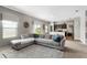 Spacious living room showcasing a comfortable sectional sofa and open-concept design to the kitchen at 16413 Bloom Ct, Groveland, FL 34736