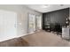 Home office with a desk, shelving, and neutral carpet flooring at 16413 Bloom Ct, Groveland, FL 34736