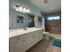 Bathroom with a tiled shower, white cabinetry, and a spacious countertop at 1733 Weeping Elm Cir, Port Orange, FL 32128