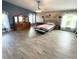 Bright bedroom featuring wood floors, a ceiling fan, and ample natural light at 1733 Weeping Elm Cir, Port Orange, FL 32128